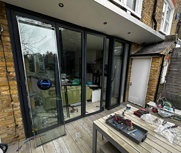 A specially trained expert repairing a set of Bifold garden doors