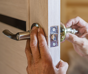 Locksmith professionally fitting new components to internal door