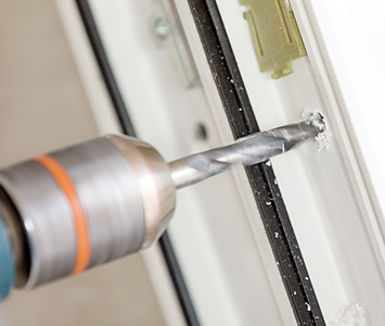 Locksmith repairing a uPVC door